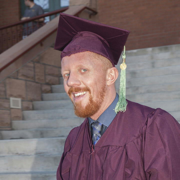 Headshot of Thomas Williams in cap and gown for graduation